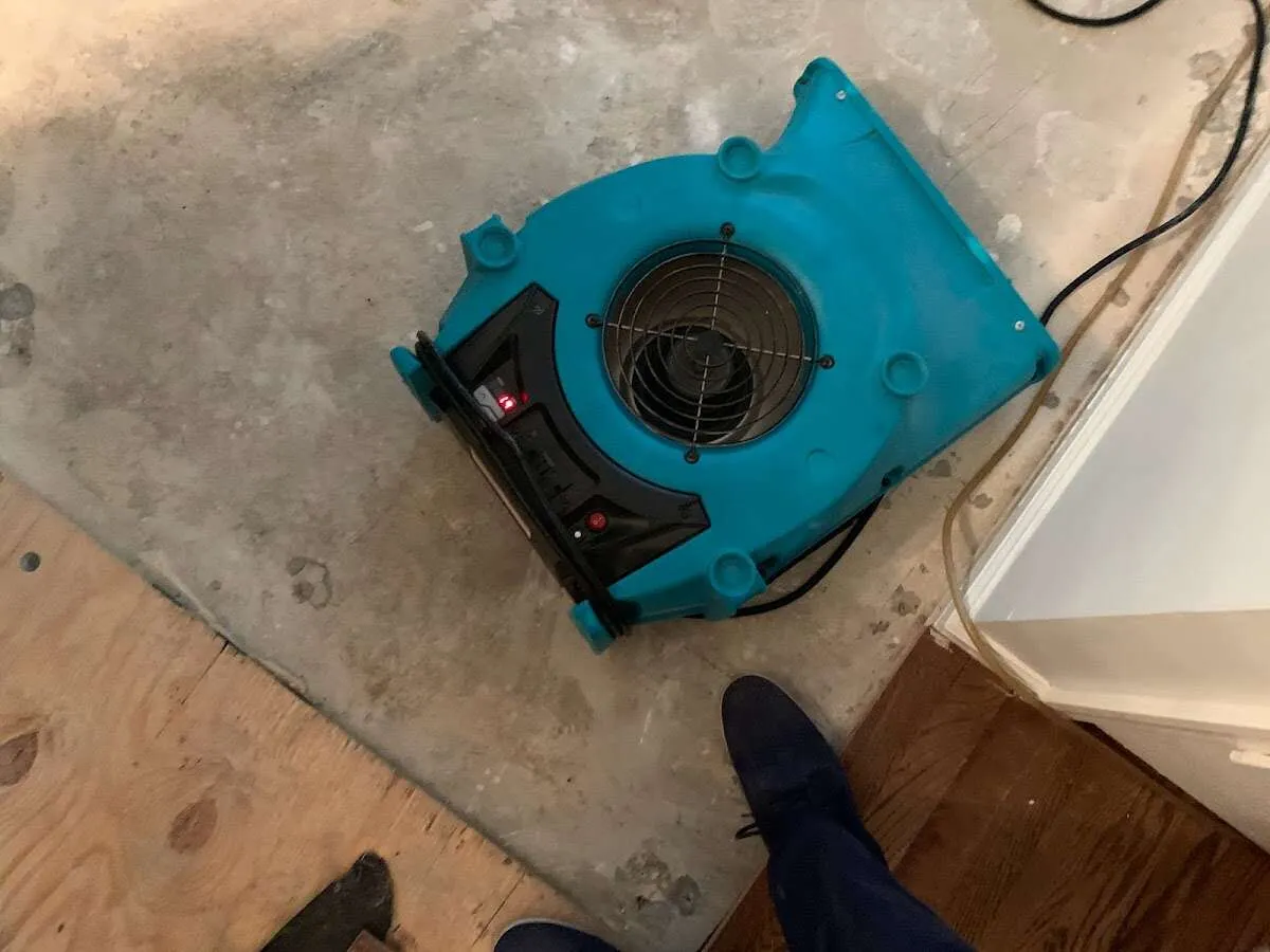 Air mover drying subfloor during Leak Detection & Repair in Grantsville